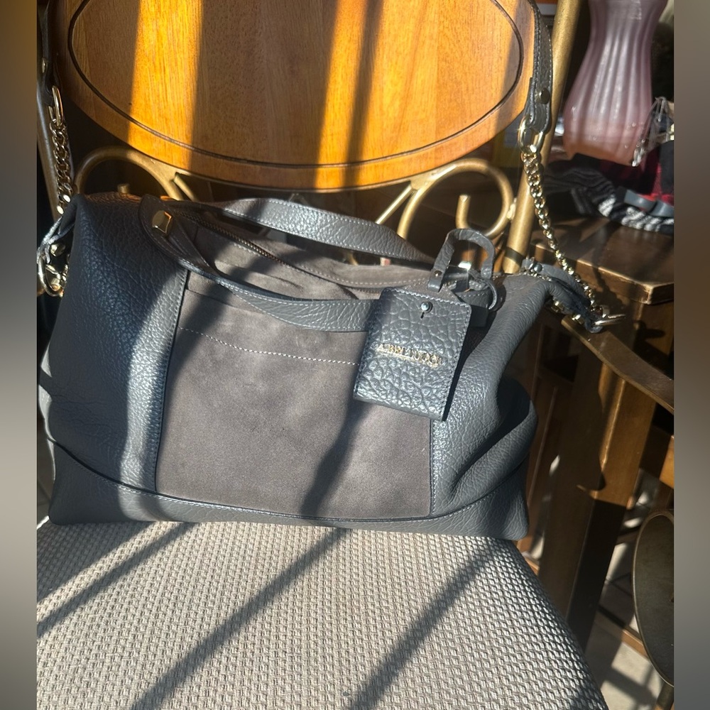 A Bellucci Black and Gold Duffel Bag with Structured Design